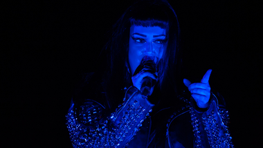 Woman singing with a blue light on her