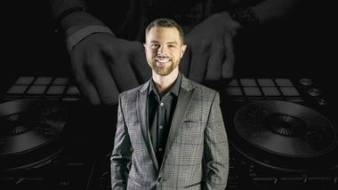 Headshot of a man with Dj tables