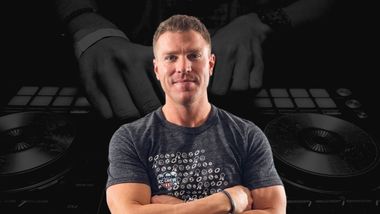 Headshot of a man with Dj tables