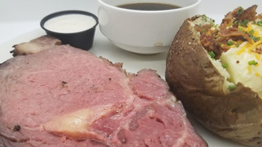 prime rib with loaded baked potato and au jus