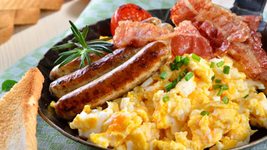 breakfast skillet with scrambled eggs, sausage and bacon